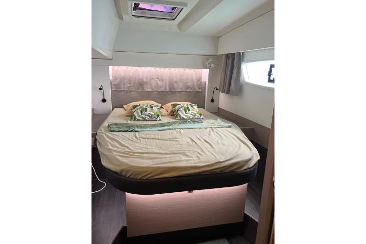 Luxurious bedroom interior of 2023 Fountaine Pajot Astrea 42 Catamaran with modern bedding.