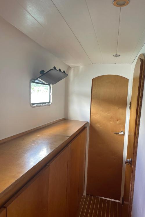 Narrow wooden hallway with window and door in Custom KSENIA 149, 2010 model.