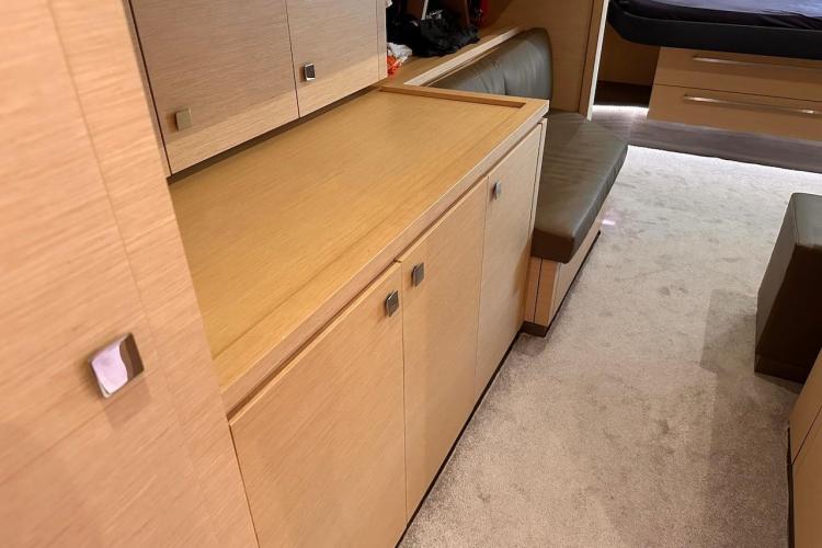 Interior of 2016 Fountaine Pajot Ipanema 58 yacht, featuring sleek wood cabinetry and seating.