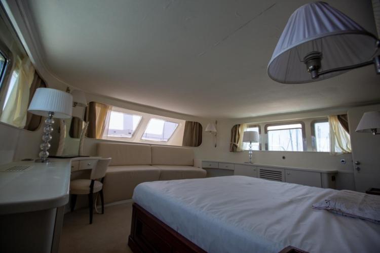 Luxurious interior of a 1972 Benetti 33 yacht, featuring elegant furnishings and ample natural light.