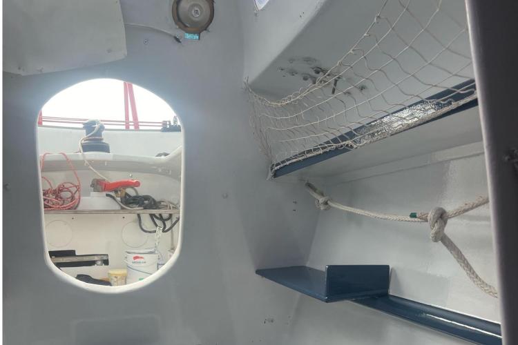 Interior of a 1994 Coulombel Trimaran, featuring ropes and nautical equipment.