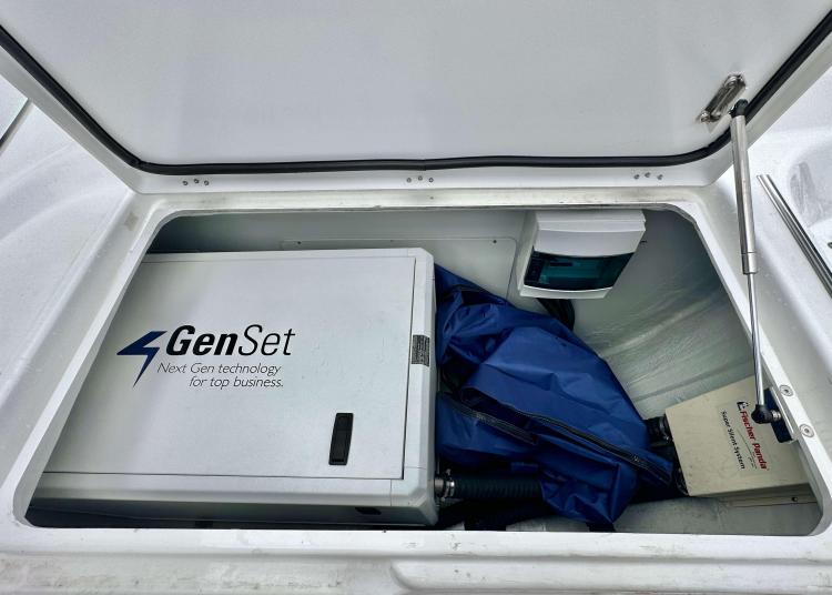 Compartment of 2023 Lagoon 46 with GenSet generator and storage items.