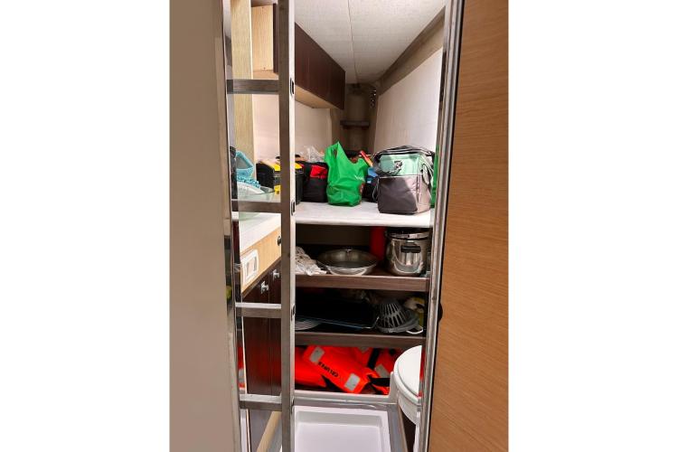 Storage area inside 2016 Fountaine Pajot Ipanema 58 yacht with shelves and various items.