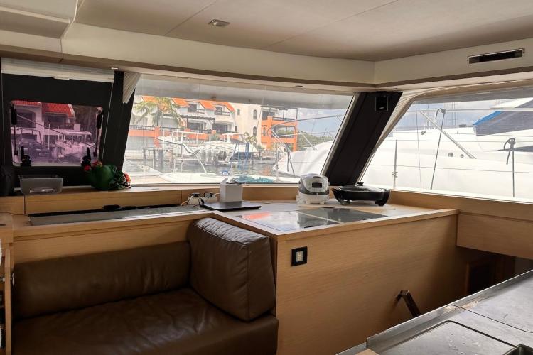 Interior of 2016 Fountaine Pajot Ipanema 58 yacht with modern seating and large windows.
