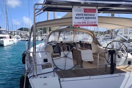 2017 Dufour 460 Grand Large yacht docked, featuring spacious deck and sales sign.