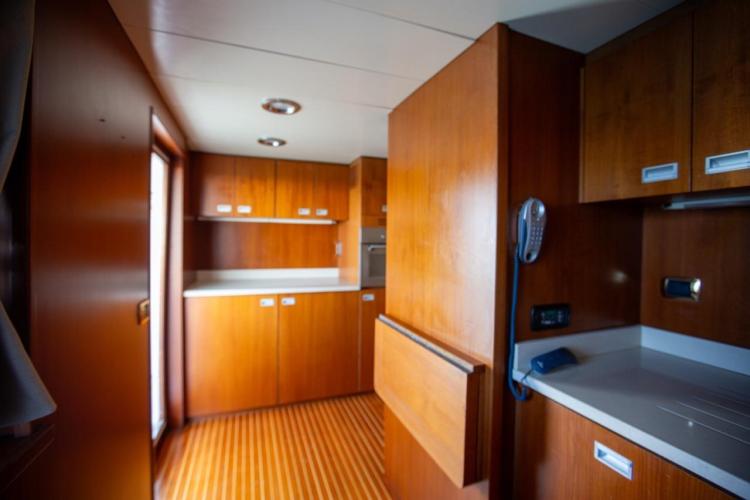 Interior of 1972 Benetti 33 yacht with wooden cabinetry and modern fixtures.
