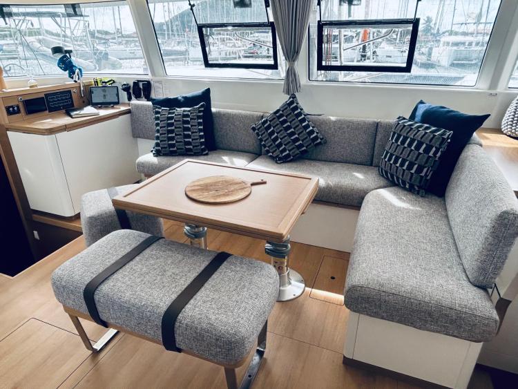 Luxurious interior of 2024 Excess 14 yacht with modern seating and dining area.