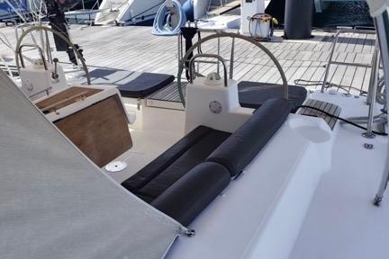2017 Dufour 460 Grand Large yacht deck with dual steering wheels and seating area.