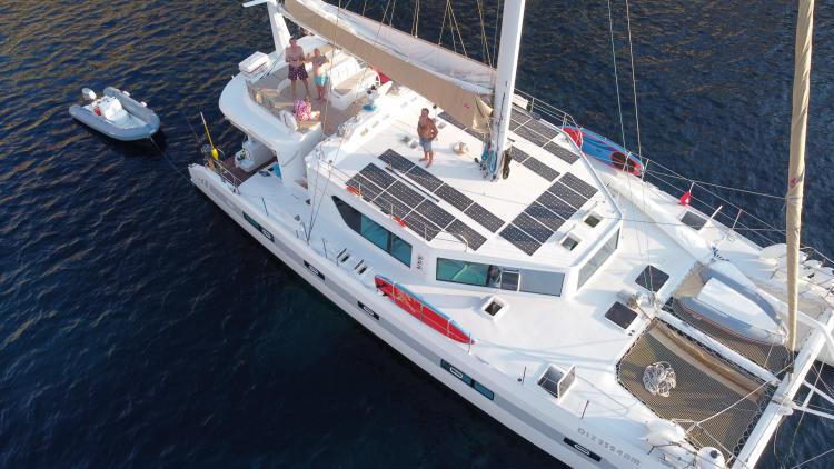 Aerial view of 2019 Squalt Marine CK 64 yacht with solar panels and people on deck.