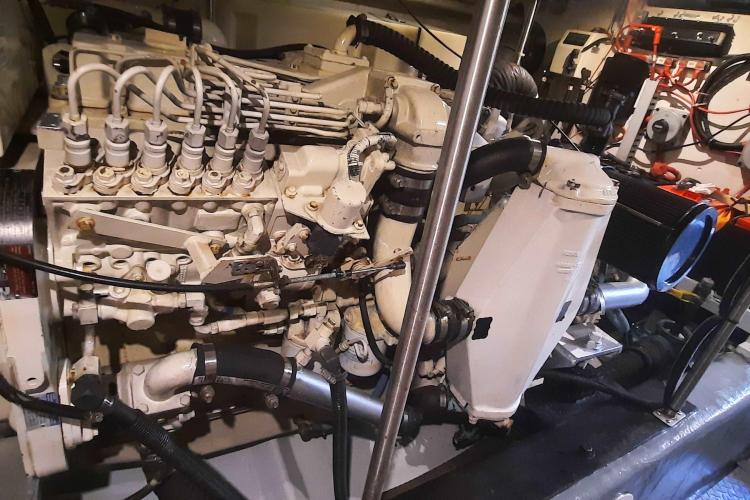 Engine room of a 2000 Carver 530 Voyager Pilothouse, showcasing complex machinery and components.