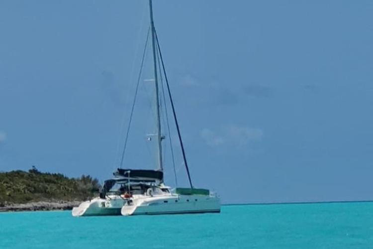 Catamaran Fountaine Pajot Bahia 46, 1999, anchored in turquoise waters.