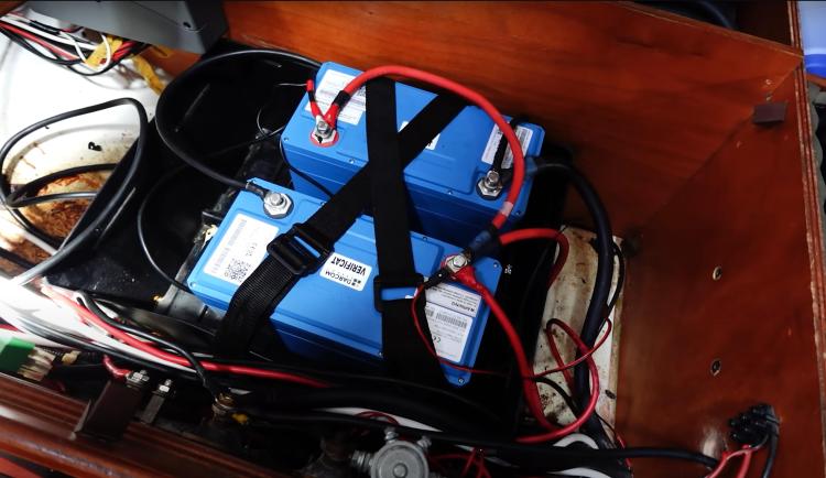 Battery compartment of a 2005 Beneteau Cyclades 43.3 sailboat with wiring and connections.