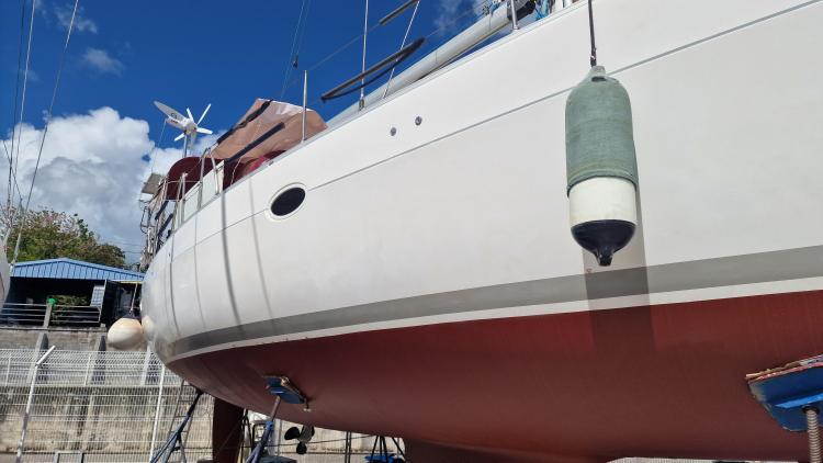 2007 Elan Impression 434 sailboat on dry dock, blue sky background.