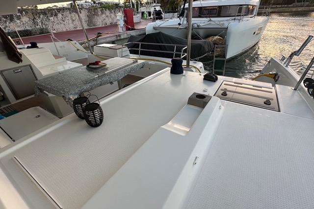 2023 Fountaine Pajot Elba catamaran deck with seating and table, docked at marina.