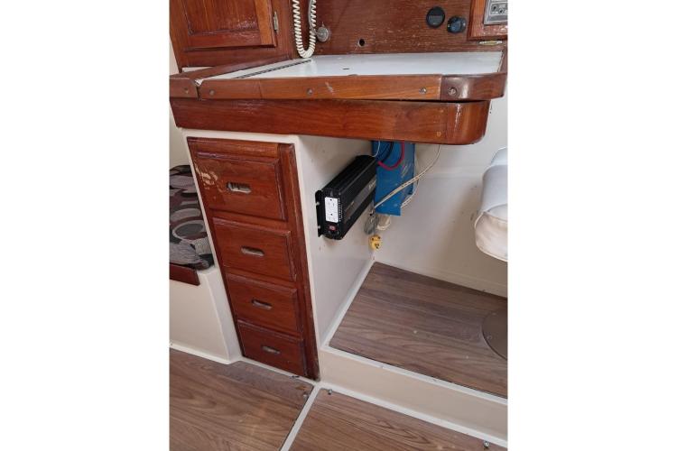 1986 Dufour CATALINA interior with wooden cabinetry and electrical panel.