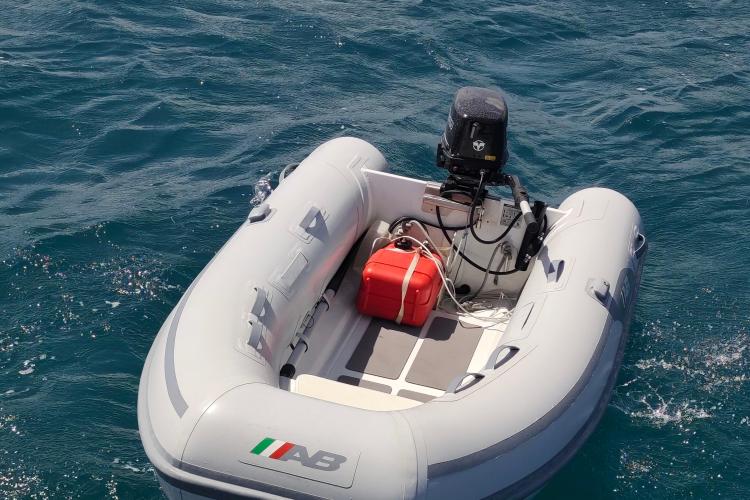 Inflatable boat with motor on blue water, associated with Beneteau Oceanis 46.1, 2019 model.