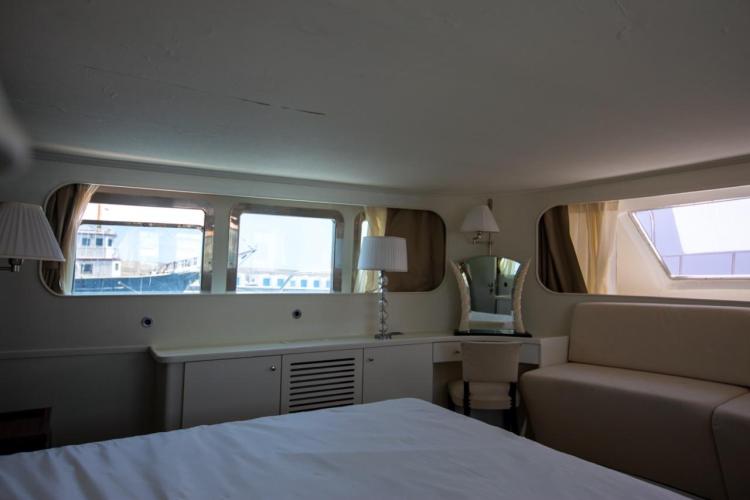 Interior of 1972 Benetti 33 yacht with elegant furnishings and large windows.