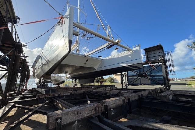 Etoile Marine Maxi Cat 24 catamaran on dry dock, 2004 model, under clear blue sky.