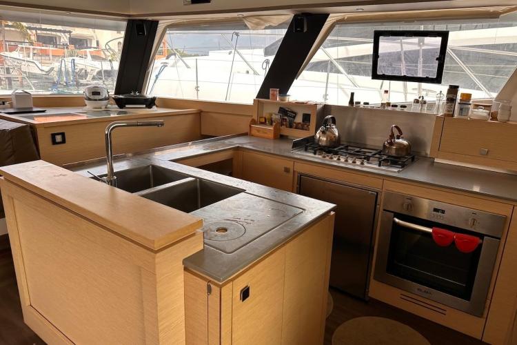 Modern kitchen interior of 2016 Fountaine Pajot Ipanema 58 yacht with stainless steel appliances.