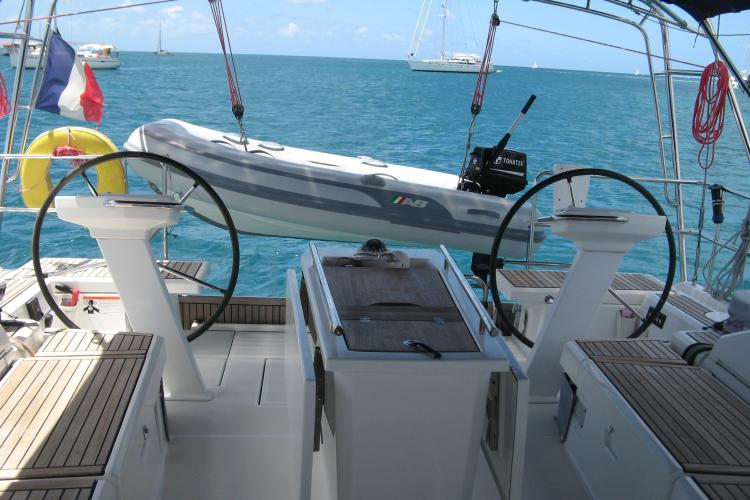 Cockpit view of 2019 Beneteau Oceanis 46.1 yacht with dinghy and ocean backdrop.