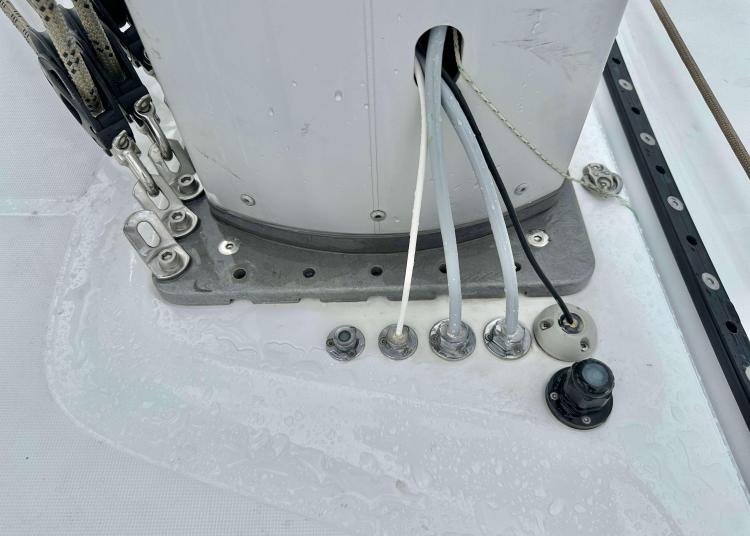 Base of a 2023 Lagoon 46 sailboat mast with rigging and cables.