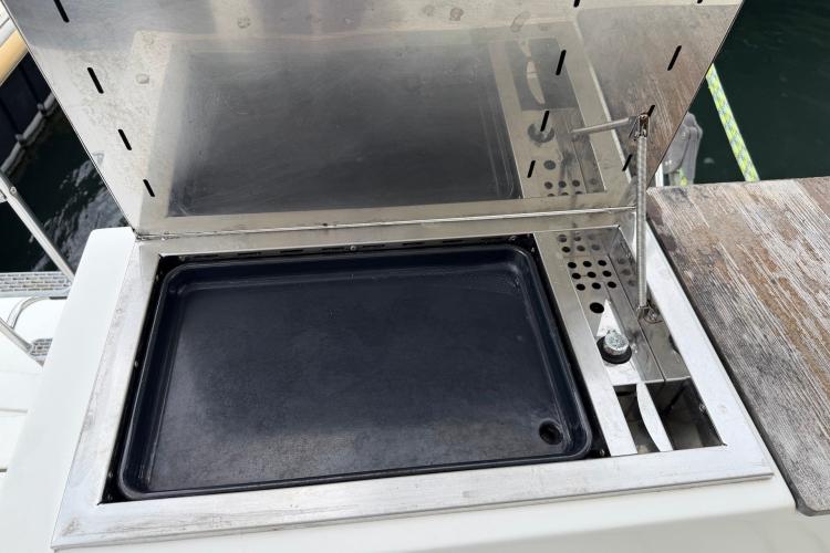 Outdoor grill on a 2020 Fountaine Pajot Astrea 42 yacht, open lid, stainless steel design.