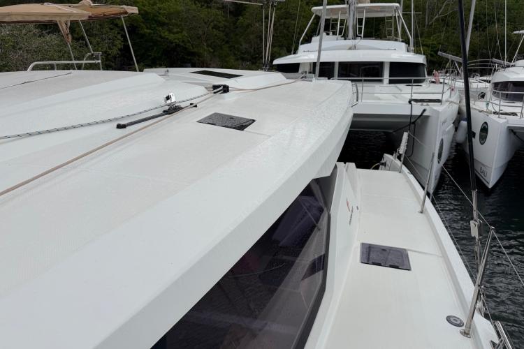 2020 Fountaine Pajot Astrea 42 catamaran docked, showcasing sleek design and spacious deck.