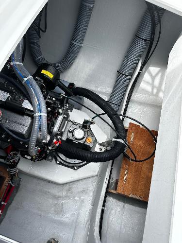 Engine compartment of 2024 Excess 11 boat with visible hoses and components.