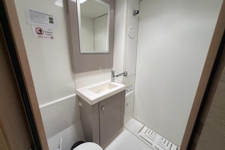 Bathroom interior of 2020 Fountaine Pajot Astrea 42 catamaran, featuring modern sink and mirror.