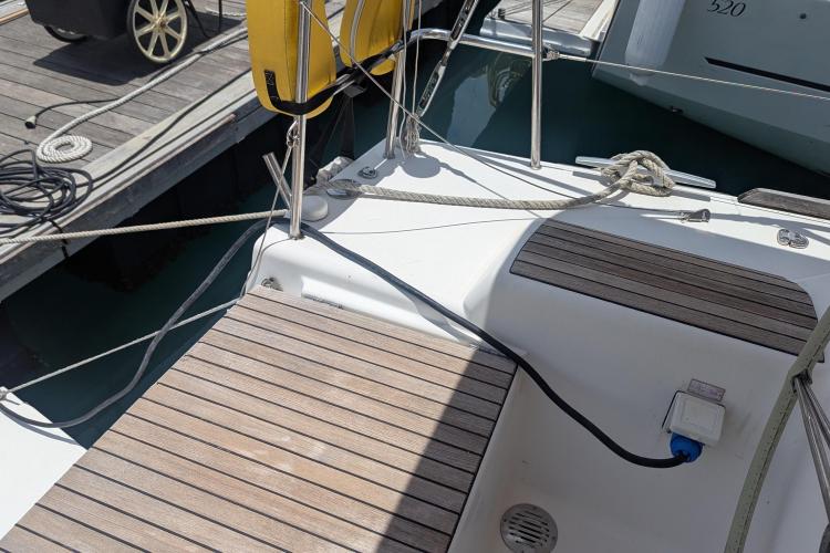 Dufour 460 Grand Large 2017 yacht deck with wooden finish and mooring ropes.