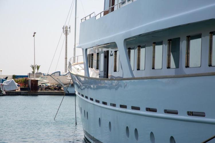 1972 Benetti 33 yacht docked in a marina, showcasing sleek design and windows.