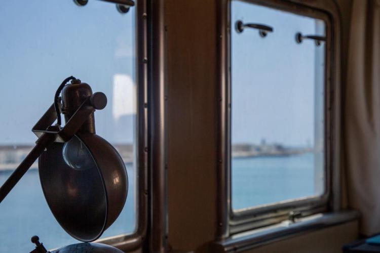 Vintage Benetti 33 yacht interior with lamp and sea view through windows, 1972 model.