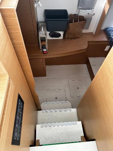 2024 Excess 11 yacht interior with wooden stairs and storage compartments.