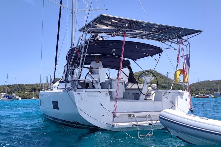 2019 Beneteau Oceanis 46.1 yacht anchored in clear blue waters.