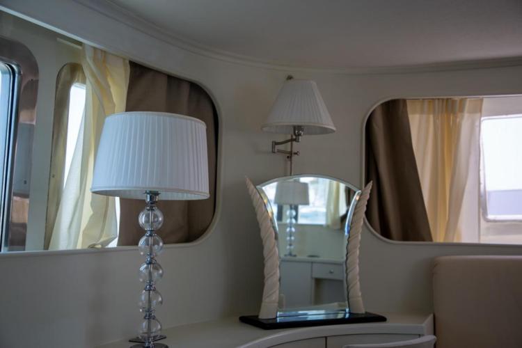 Interior of 1972 Benetti 33 yacht with elegant lamps and mirror.