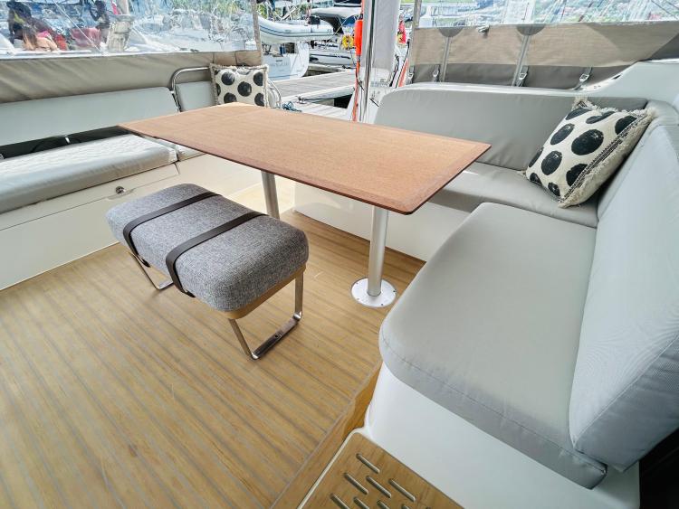 Luxurious interior of 2024 Excess 14 yacht with modern seating and wooden table.