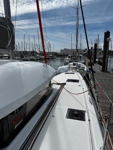 2024 Excess 11 sailboat docked at marina under blue sky.