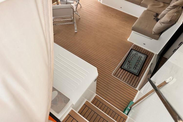 2016 Fountaine Pajot Ipanema 58 yacht interior with teak flooring and cushioned seating.
