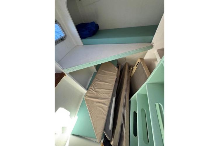 Interior of 2004 Etoile Marine Maxi Cat 24 with cushions and storage.