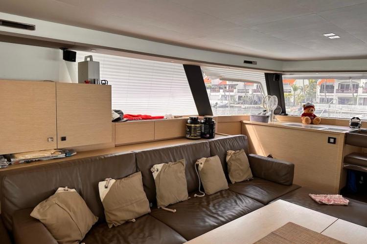 Interior of 2016 Fountaine Pajot Ipanema 58 yacht with modern furnishings and large windows.