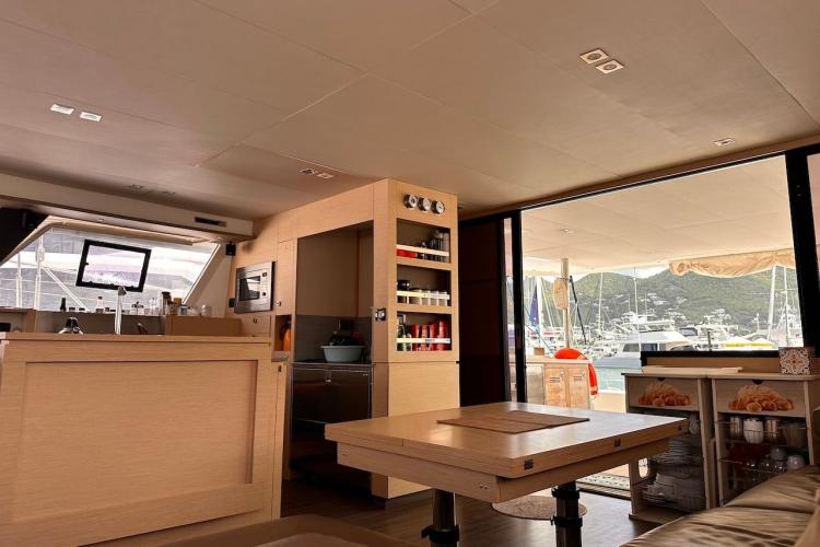 Luxurious interior of 2016 Fountaine Pajot Ipanema 58 yacht with modern kitchen and marina view.