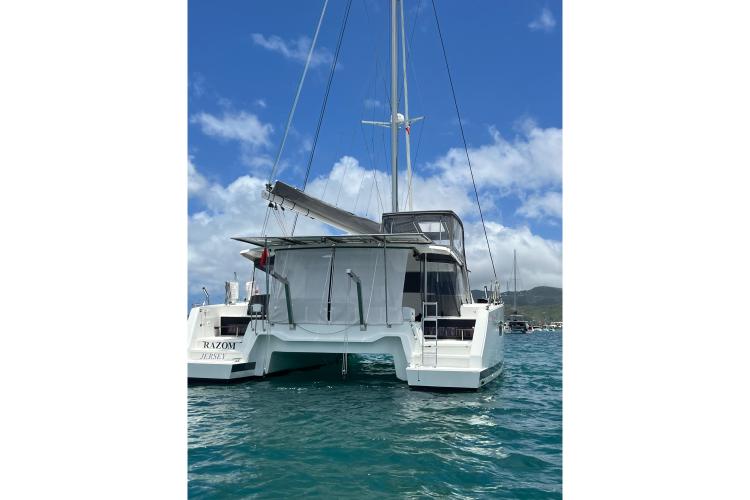 2023 Fountaine Pajot Astrea 42 Catamaran on water, rear view, clear sky.
