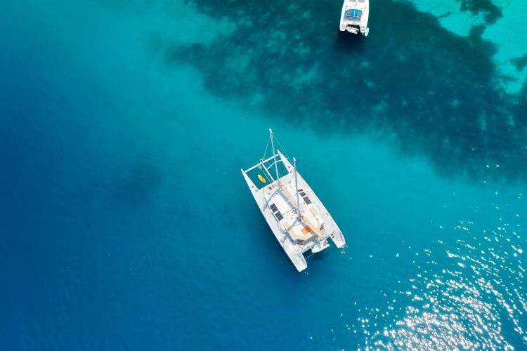 Aerial view of Etoile Marine NAUTILUS 360 catamaran on clear blue water, 2004 model.
