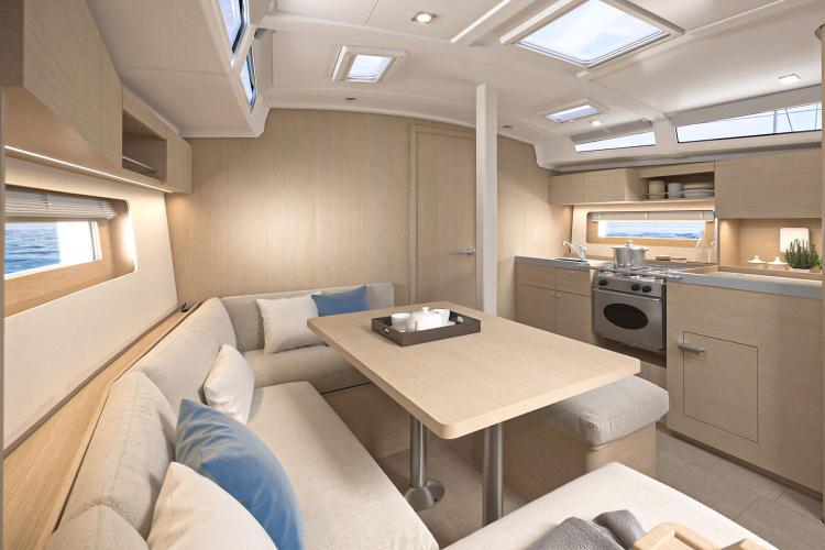 Manufacturer Provided Image: Modern interior of 2026 Beneteau Oceanis 37.1 yacht with cozy seating and kitchen area.
