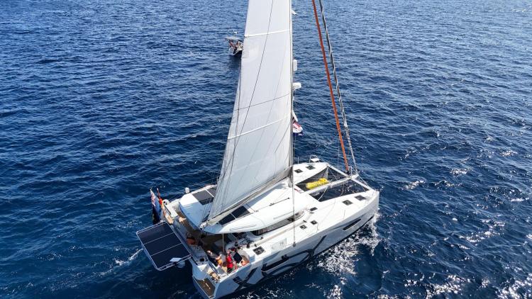 2024 Excess 14 catamaran sailing on open blue sea.